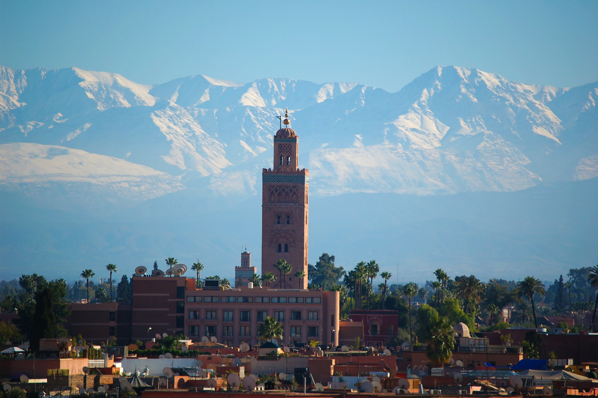 The Koutoubia mosque at dusk, with the Atlas mountains behind